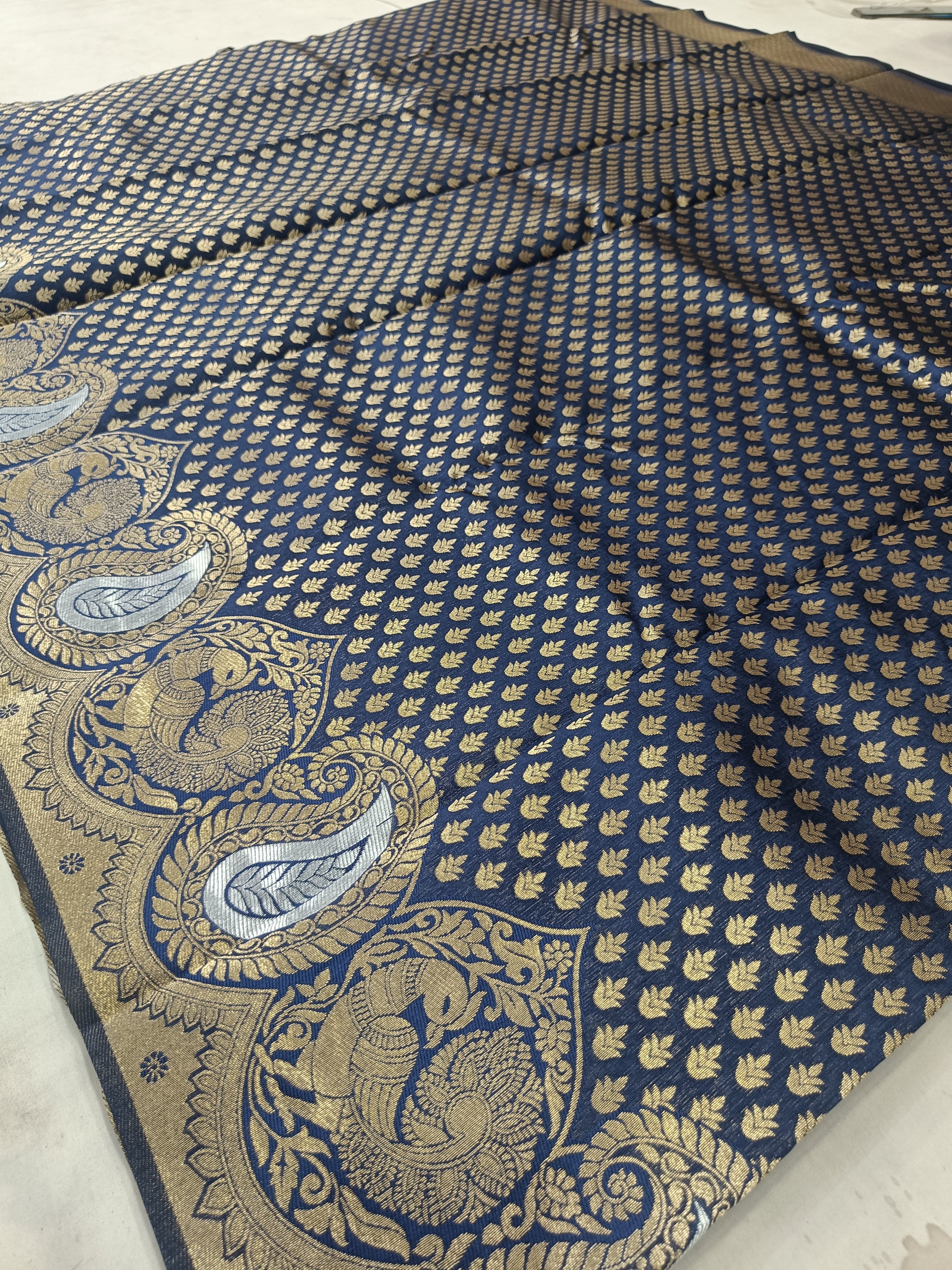 Navy blue Banarasi silk saree pallu with paisley medallion and gold vine border