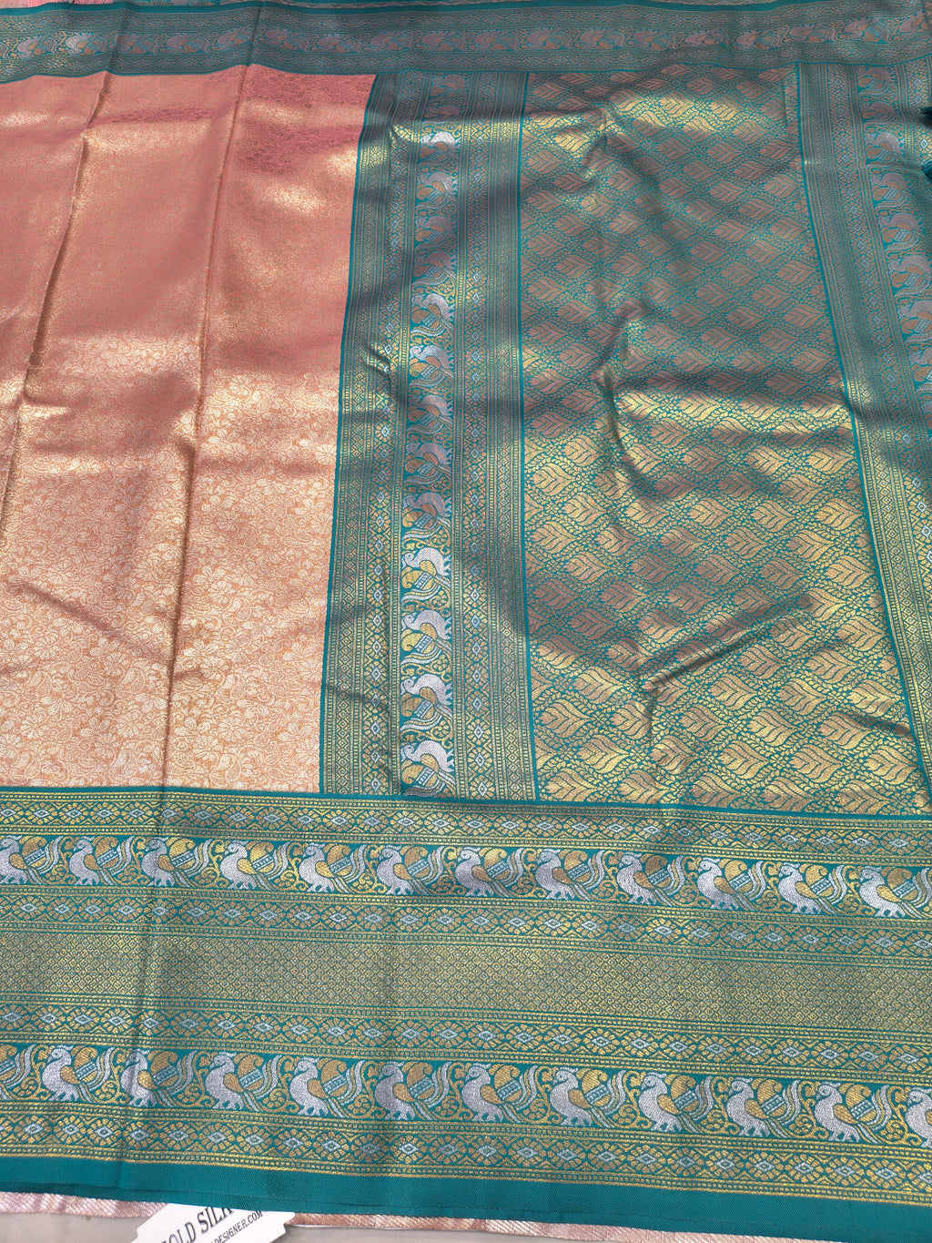 Aqua blue silk border with ornate gold woven medallions on peach saree panel