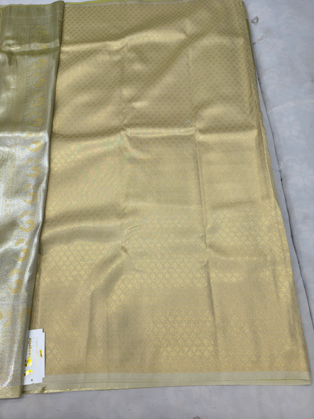 Olive green saree panel with cream-gold border and geometric woven pattern