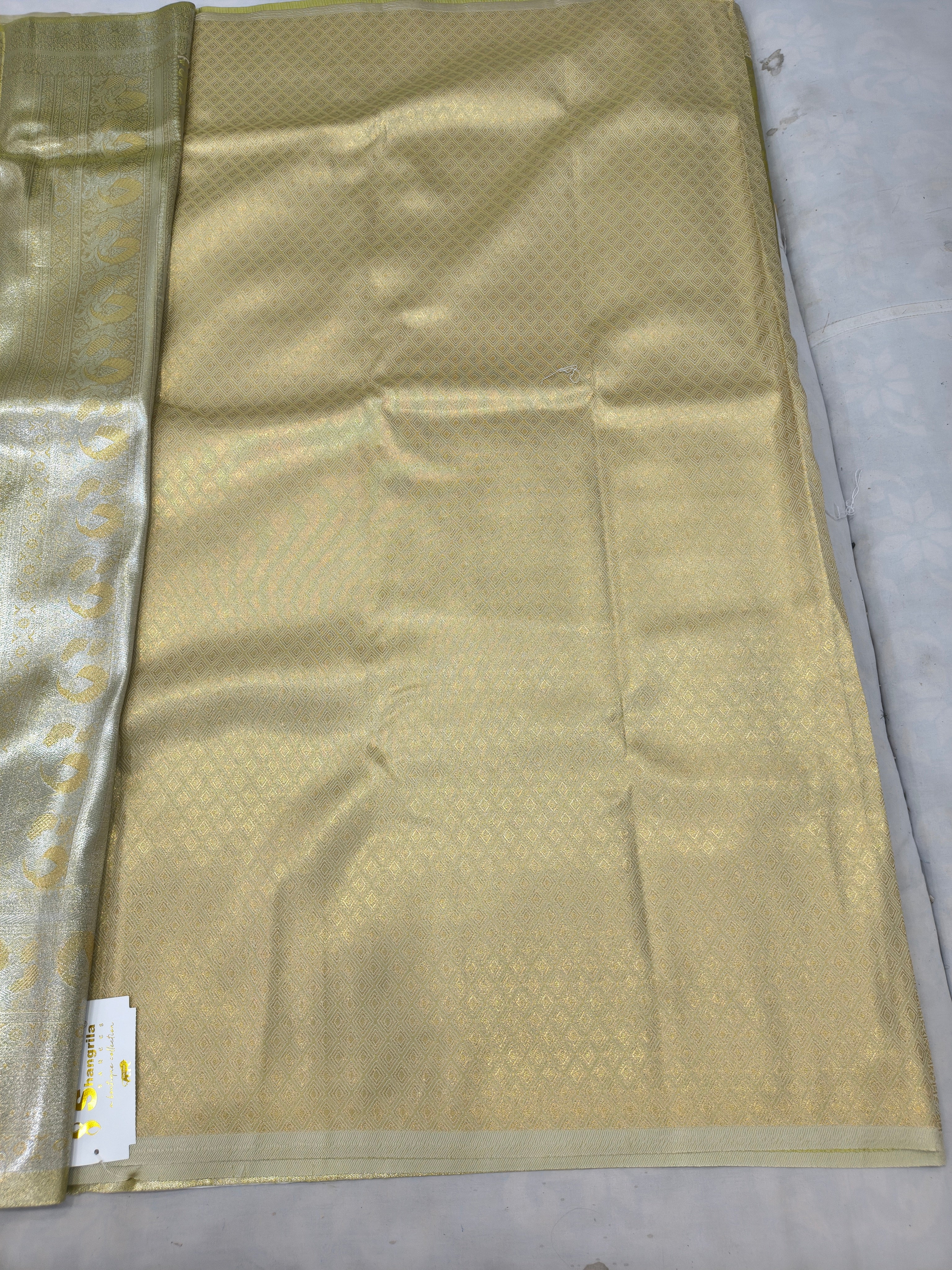 Olive green saree panel with cream-gold border and geometric woven pattern