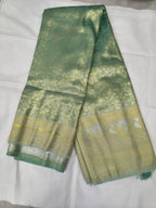 Sea green Banarasi silk saree with beige border, folded view showing woven patterns