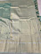 Sea green and beige Banarasi silk saree pallu detail with ornate gold-toned motifs
