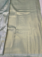 Light beige Banarasi silk saree with sea green accents and woven border