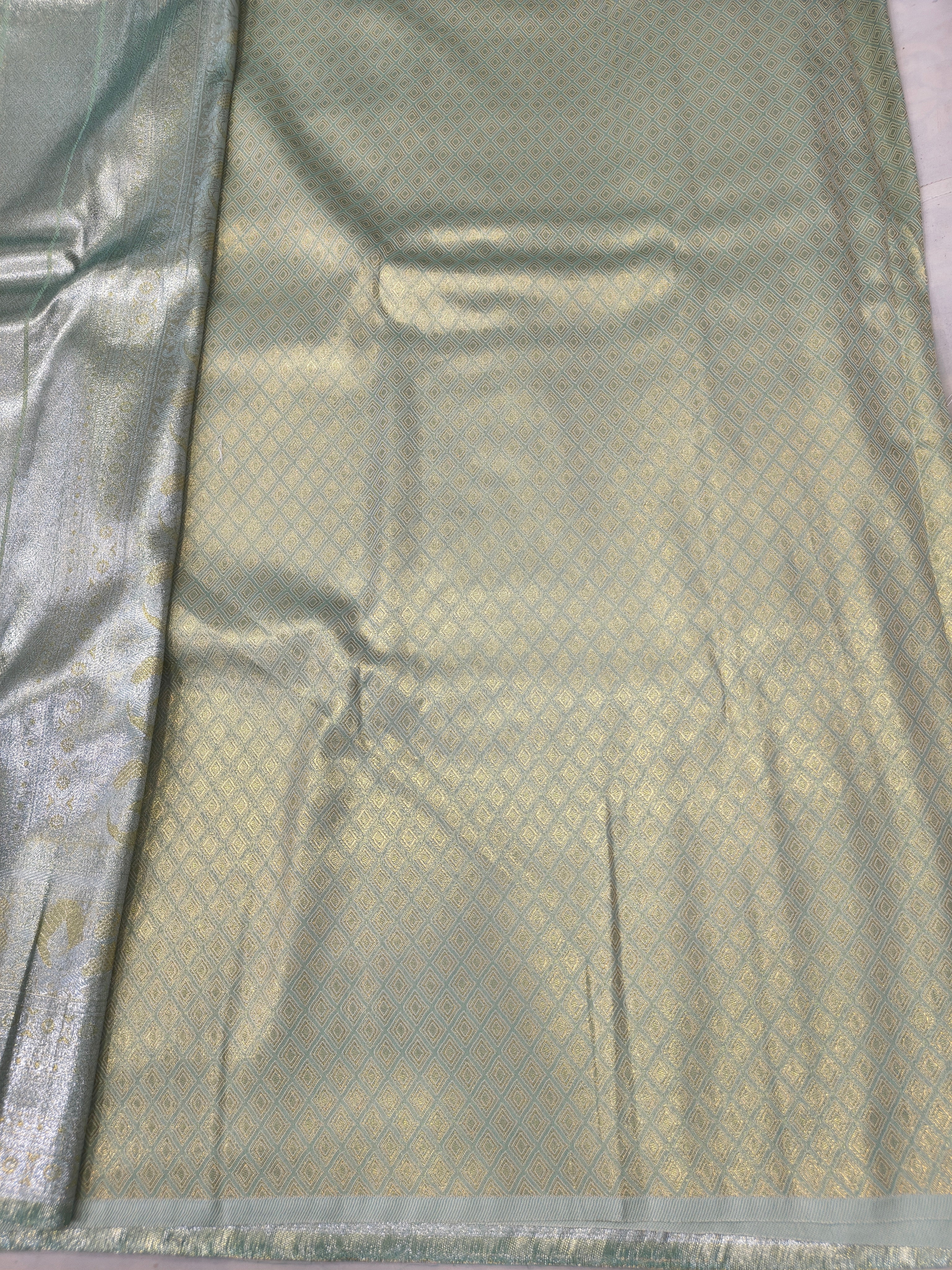 Light beige Banarasi silk saree with sea green accents and woven border