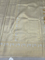 Cream Banarasi silk saree pallu fabric with gold zari motifs and woven border