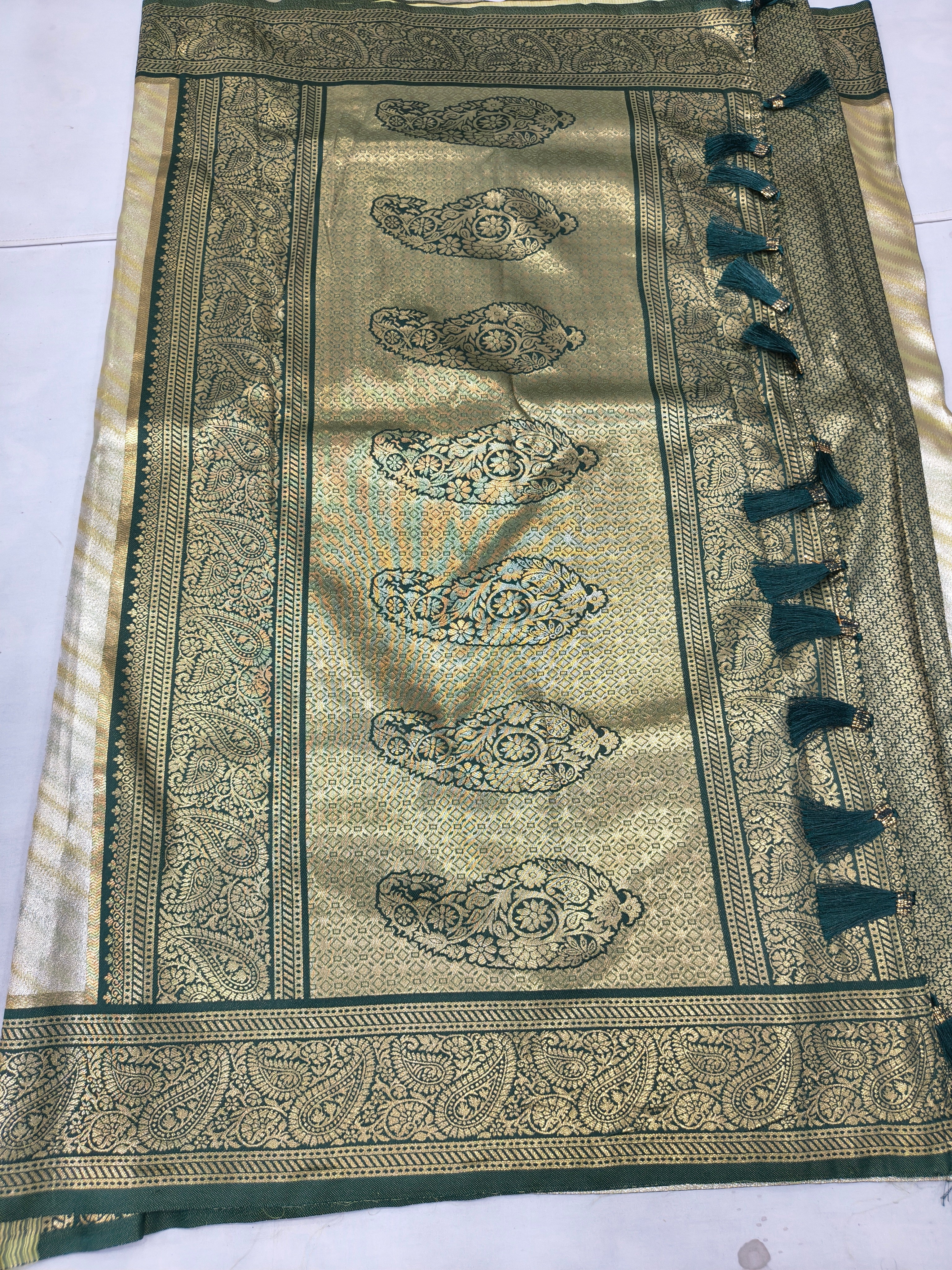 Banarasi silk saree pallu with green-gold paisley motifs and wide decorative border