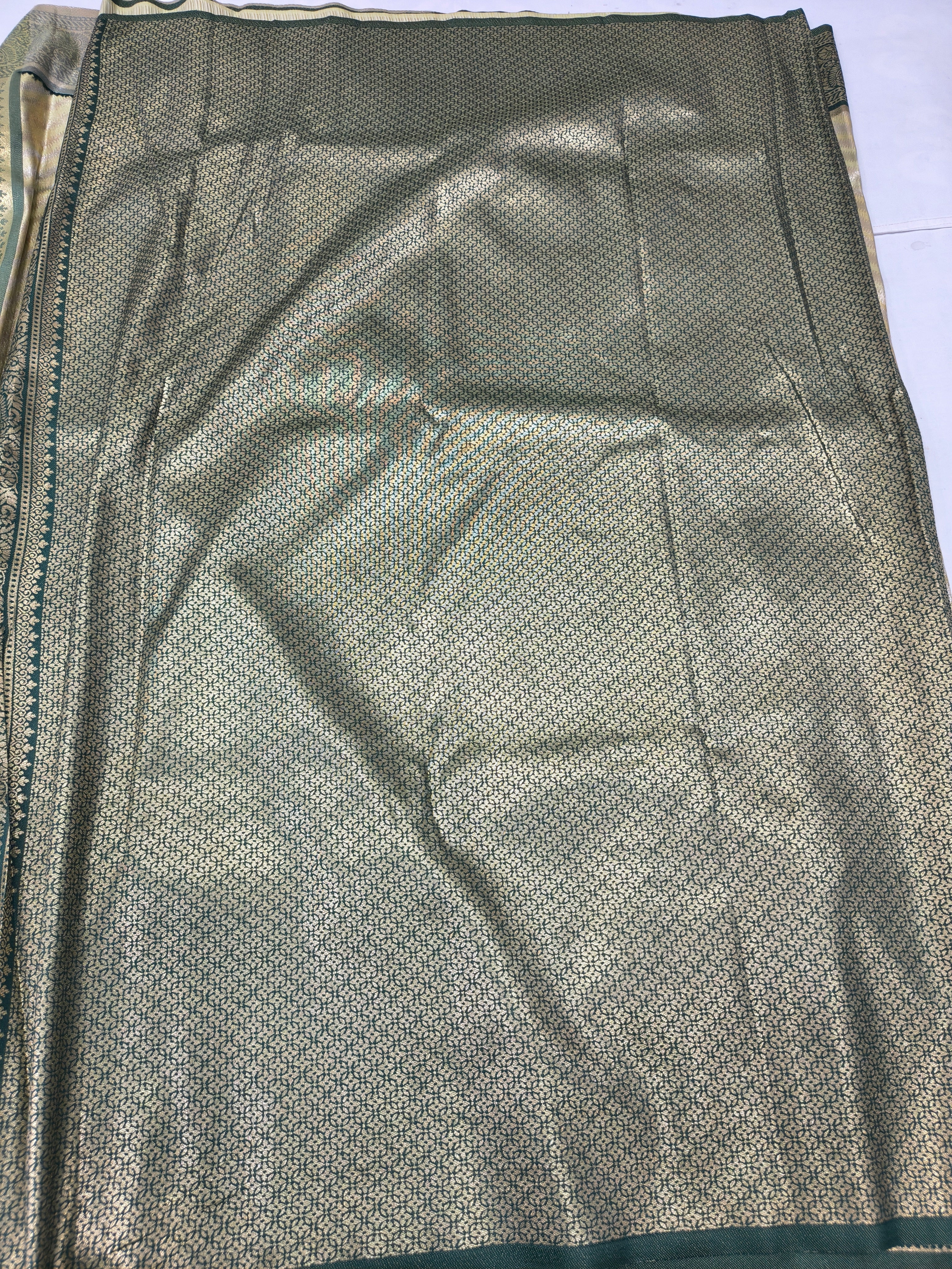 Banarasi silk saree fabric with fine olive dots and subtle metallic sheen