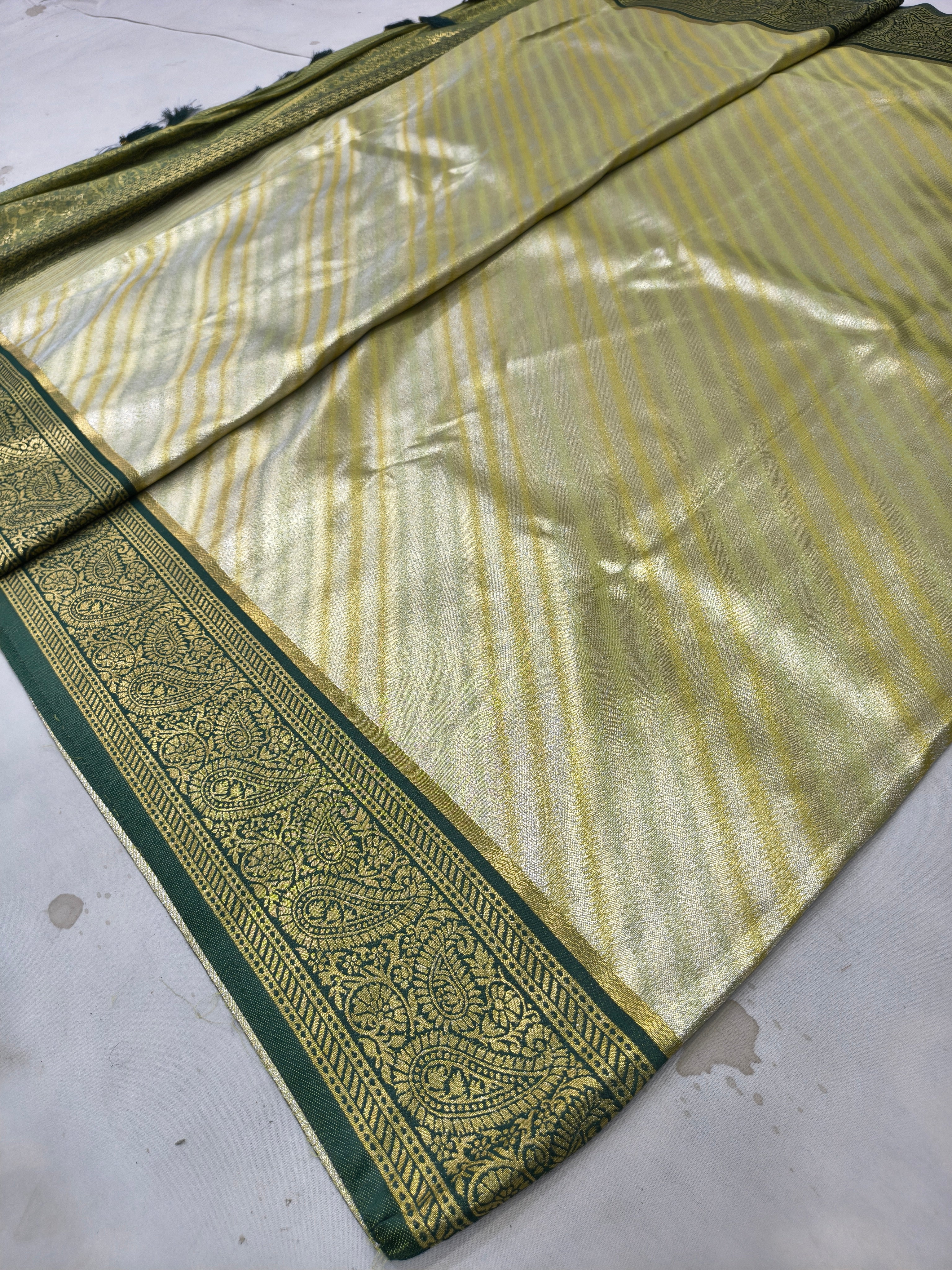 Banarasi silk saree folded view with olive border stripe detailing on beige body