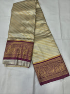 Cream-gold silk saree border panel with maroon and gold zari motifs