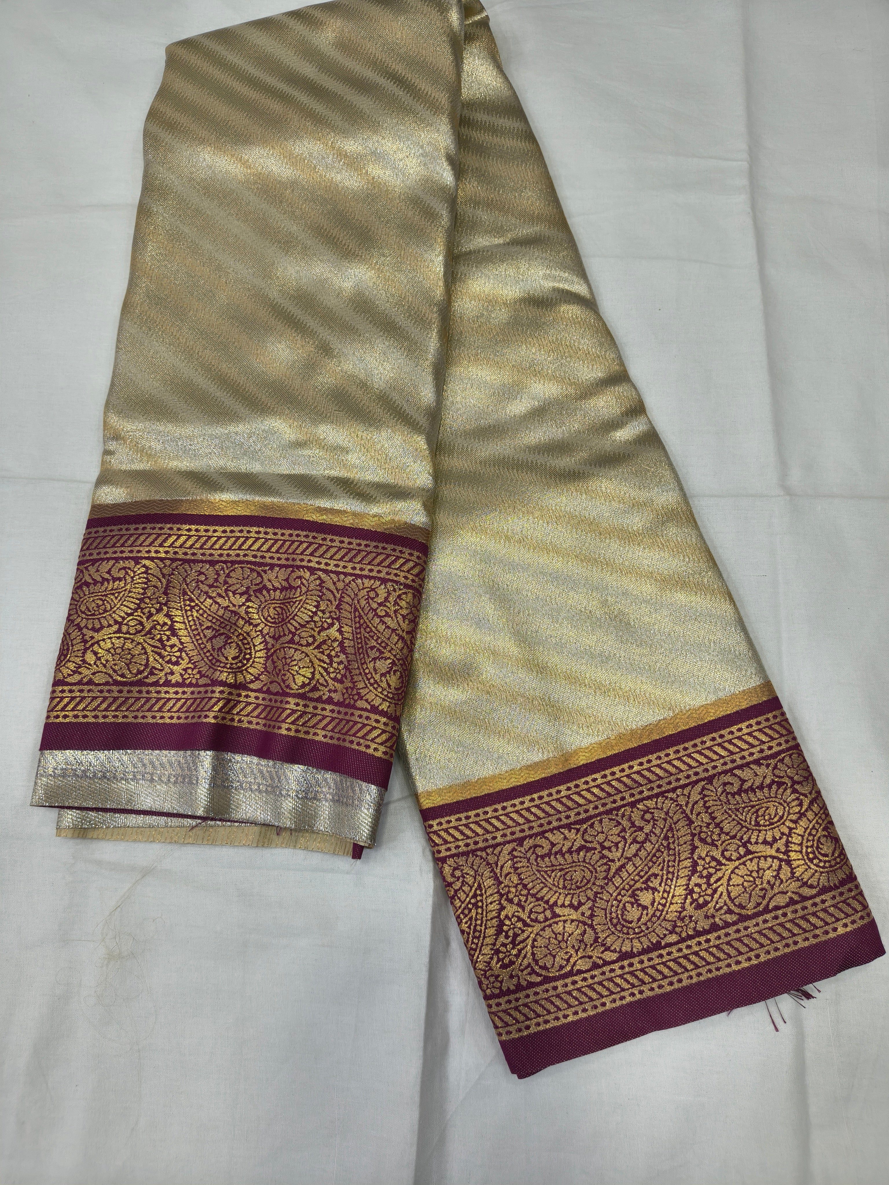 Cream-gold silk saree border panel with maroon and gold zari motifs