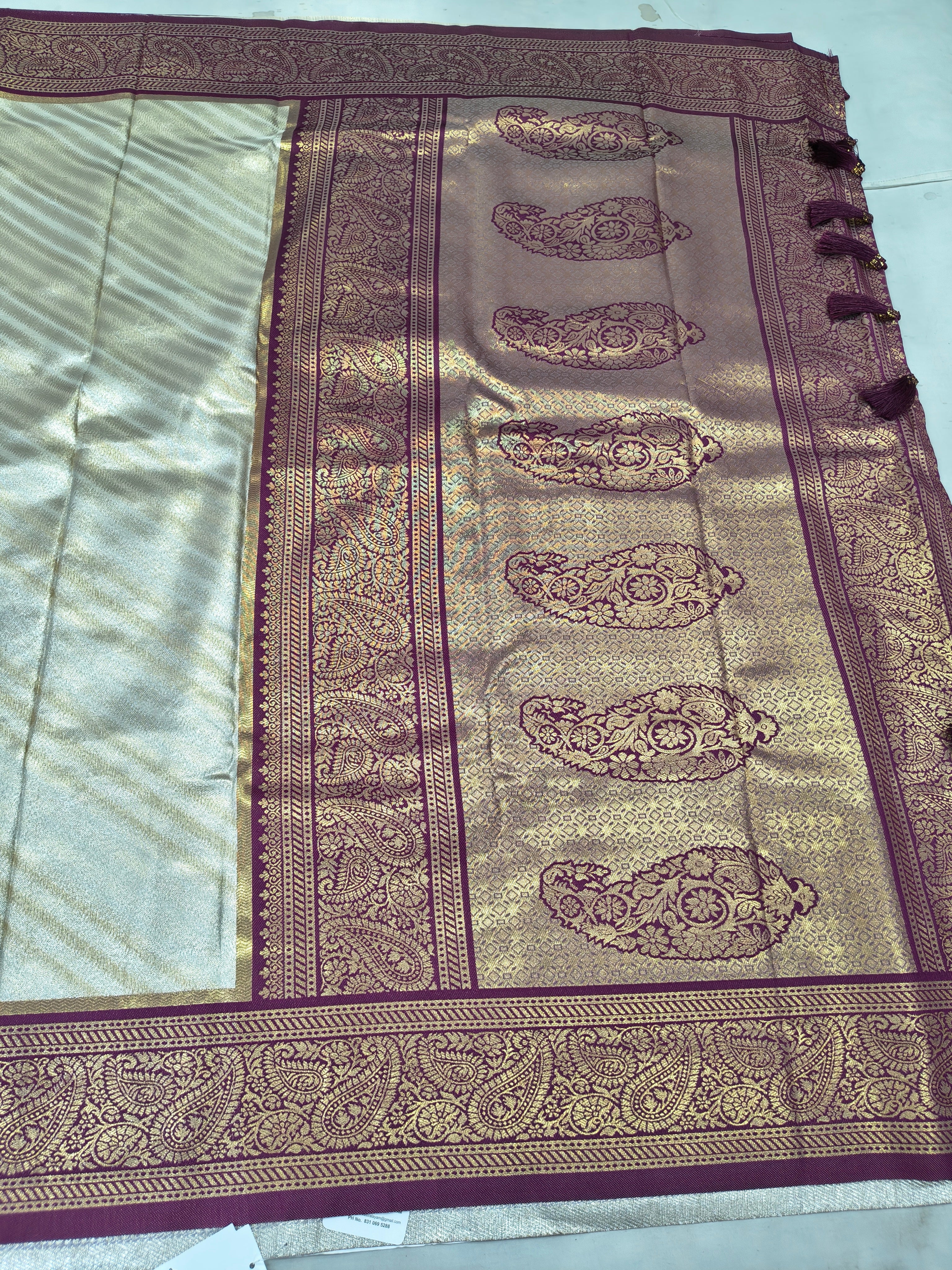 Banarasi silk saree pallu with maroon border and paisley-like gold motifs
