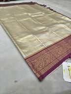 Cream-gold Banarasi silk saree with maroon border and gold zari detailing