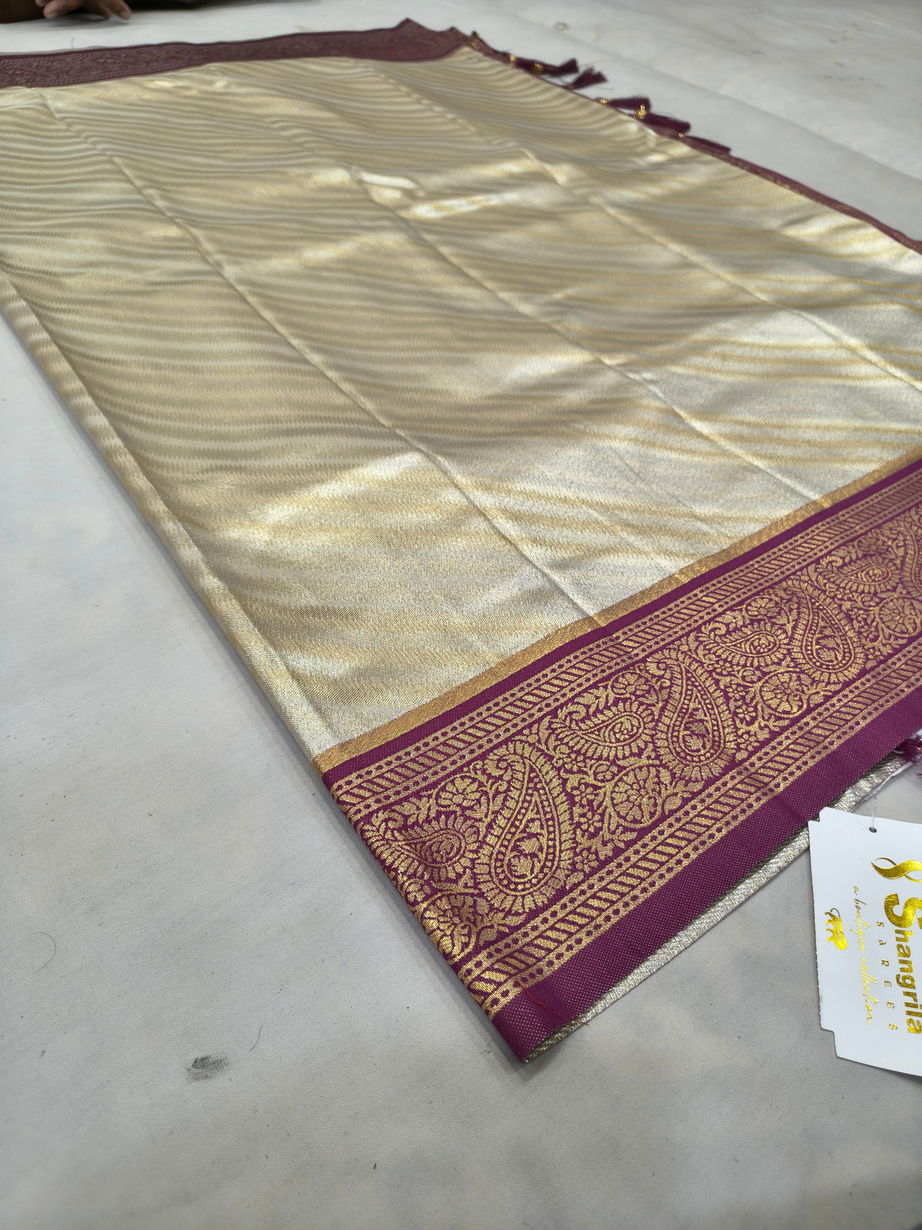 Cream-gold Banarasi silk saree with maroon border and gold zari detailing