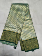 Teal and olive green Banarasi silk saree with striped body and wide gold border