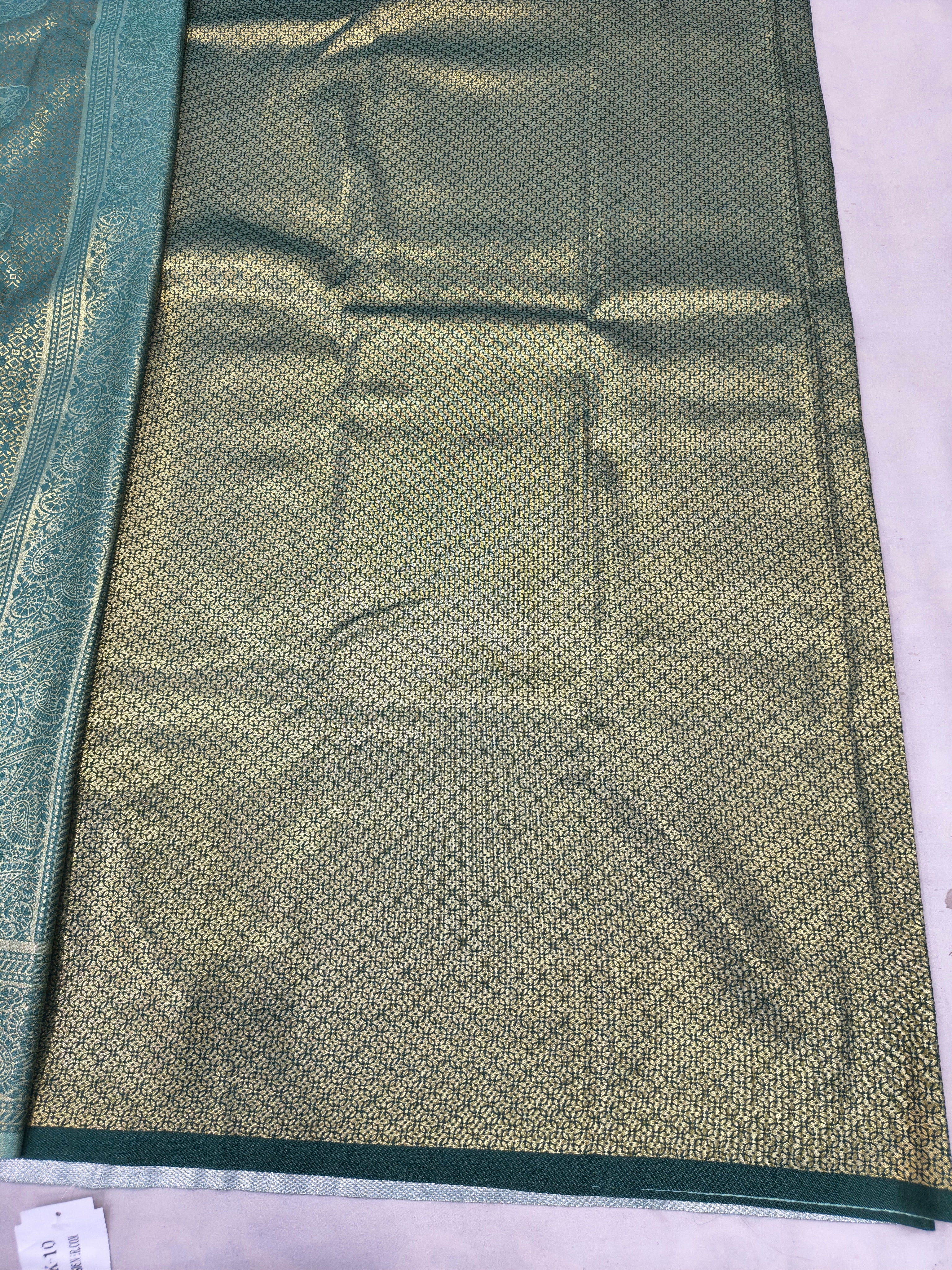 Teal and olive green Banarasi silk saree with textured woven body and inner panel
