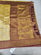 Banarasi silk saree pallu, gold brocade motifs on maroon field with ornate border
