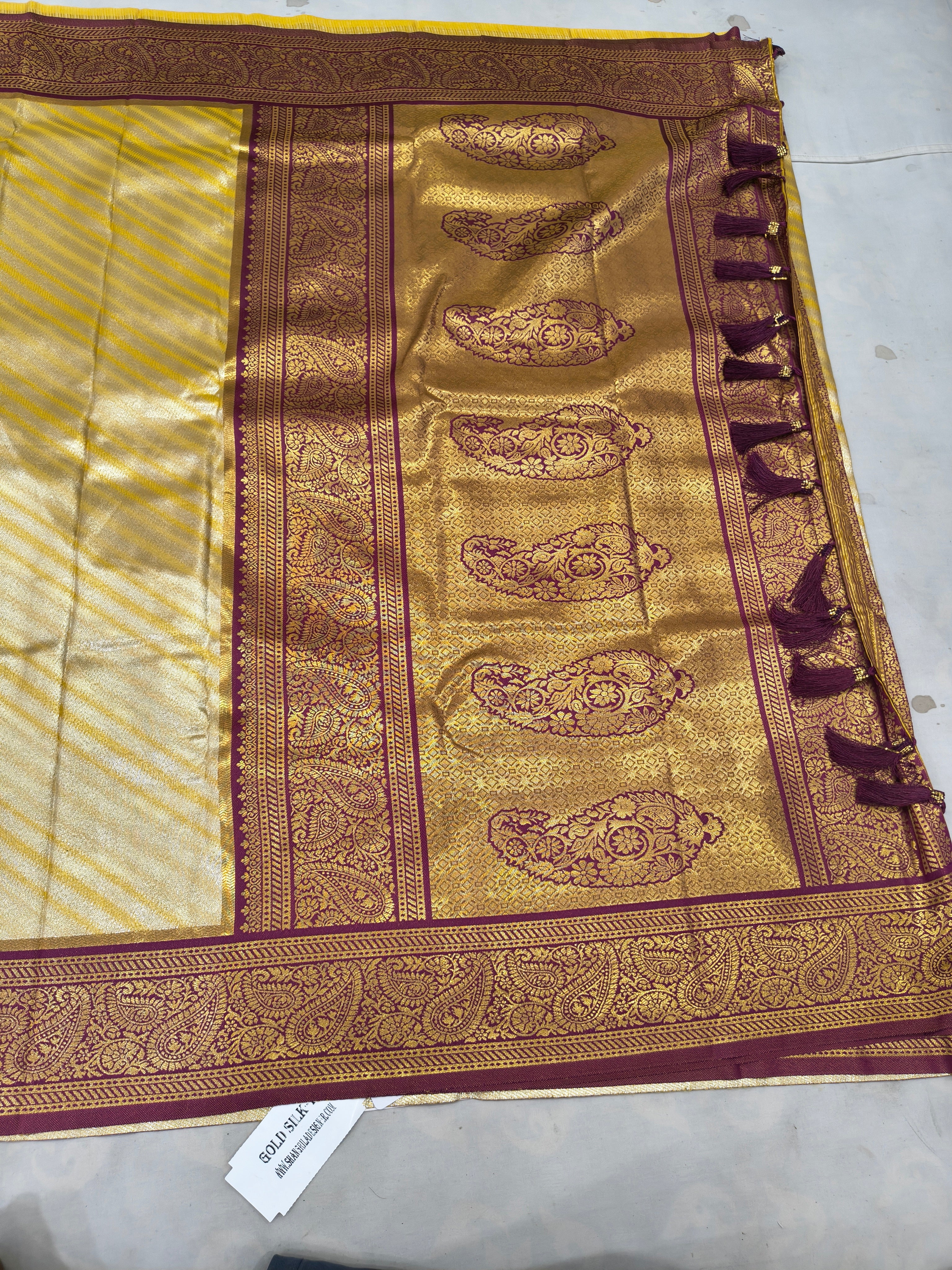 Banarasi silk saree pallu, gold brocade motifs on maroon field with ornate border