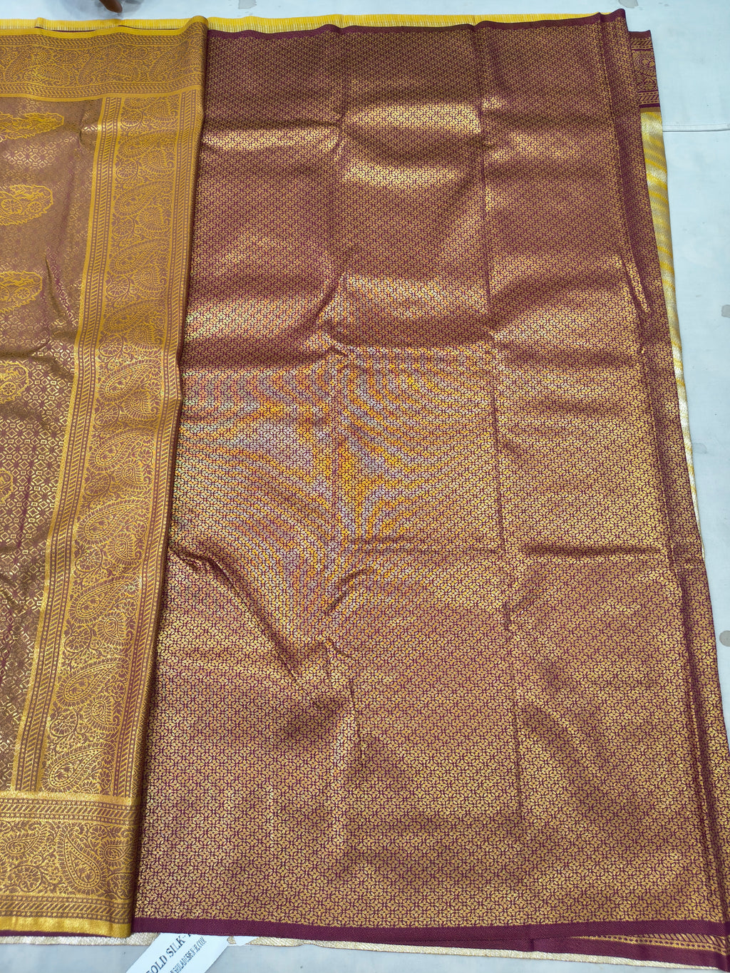 Banarasi silk saree in gold and maroon, woven panel with ornate border