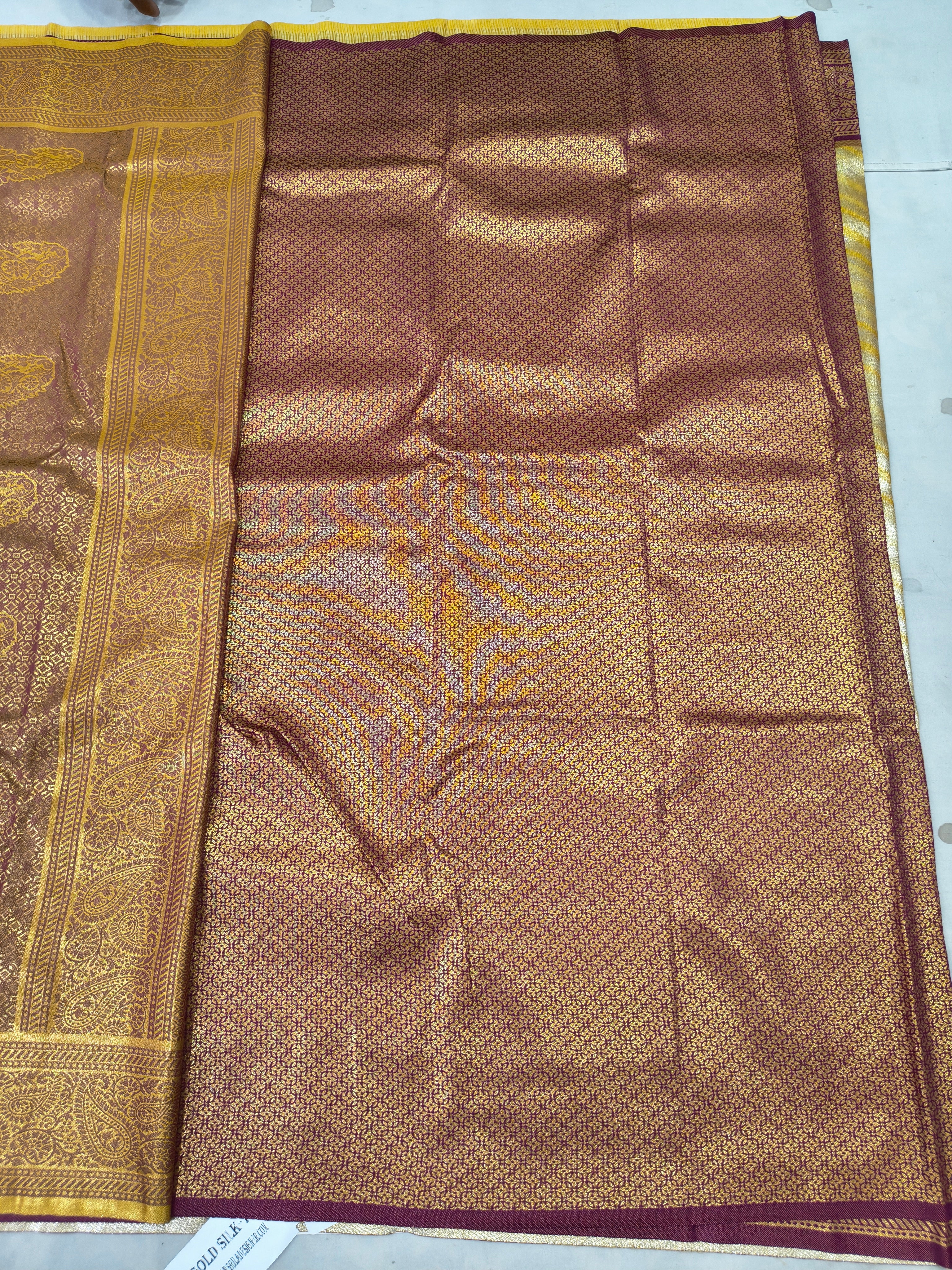 Banarasi silk saree in gold and maroon, woven panel with ornate border
