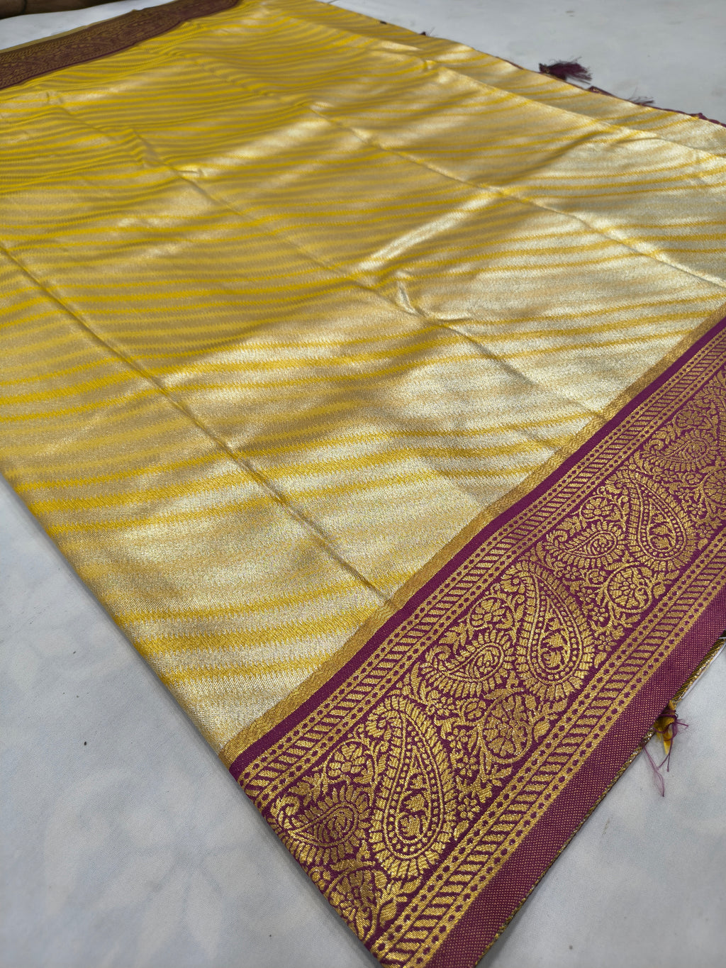 Banarasi silk saree corner, gold striped body with maroon zari border and tassels