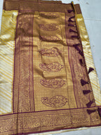 Banarasi silk saree close-up: gold-beige weave with maroon ornamental panel