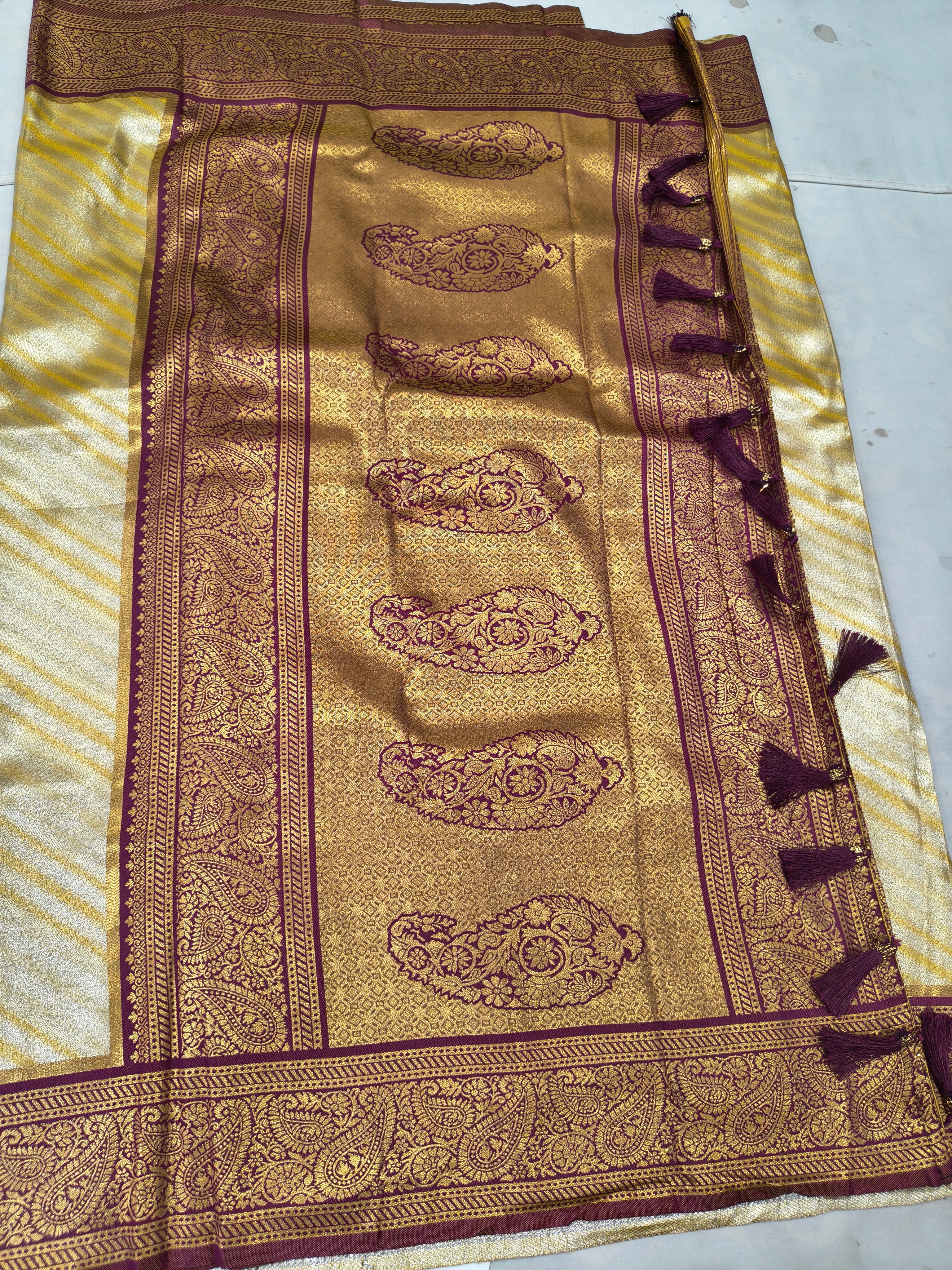 Banarasi silk saree close-up: gold-beige weave with maroon ornamental panel