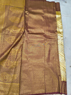 Banarasi silk saree close-up: gold-beige fabric with maroon geometric border