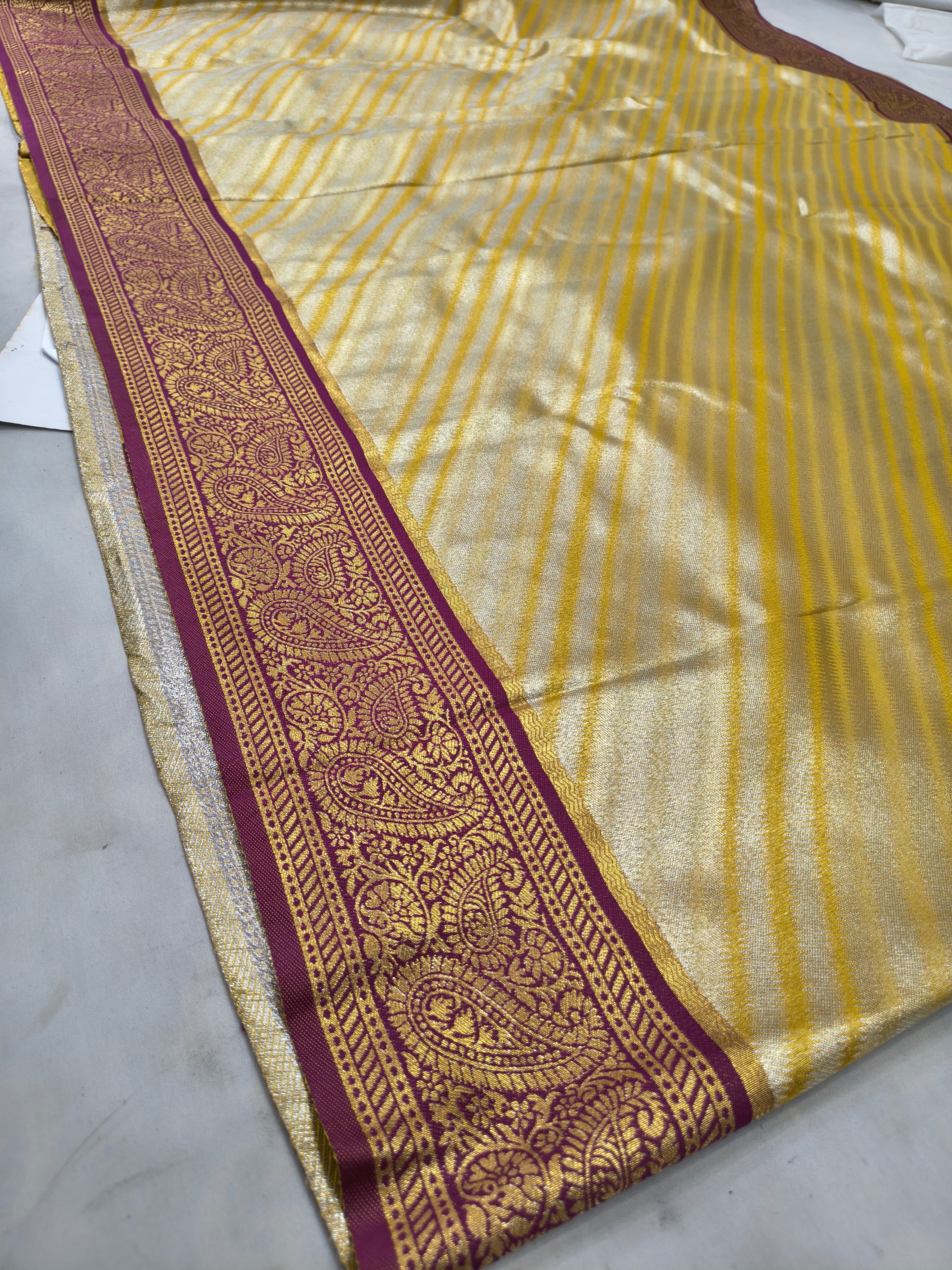 Banarasi silk saree border detail: gold-beige with maroon ornamental stripe