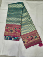 Teal zigzag Banarasi silk saree with magenta border and matching unstitched blouse piece