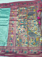 Banarasi silk saree pallu close-up with teal stripes and ornate multicolor motifs