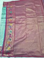 Banarasi silk saree section with pink textured body and ornate pink border on teal edge