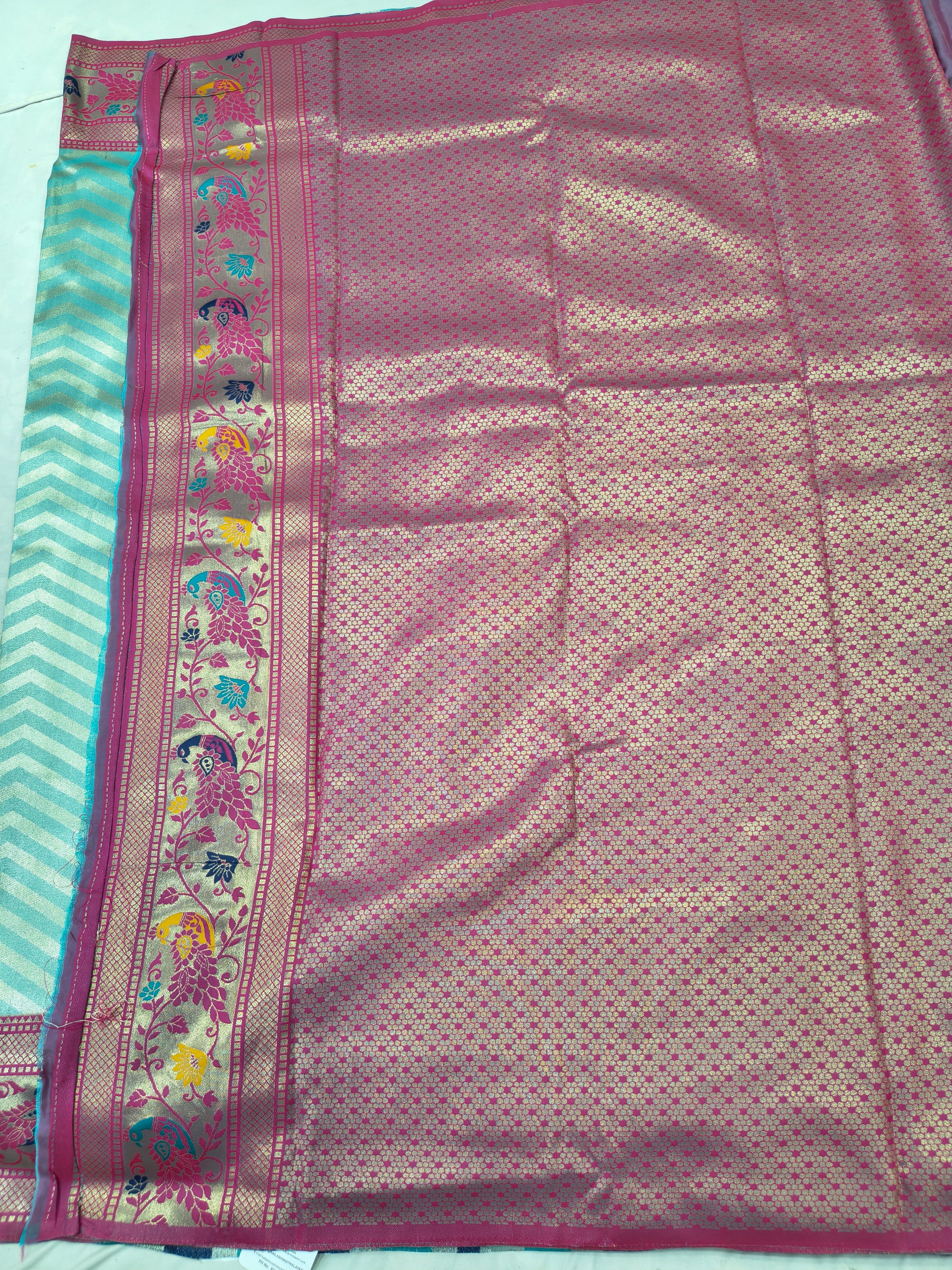 Banarasi silk saree section with pink textured body and ornate pink border on teal edge