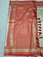 Red Banarasi silk pallu panel with geometric weave, cream border and tassel fringe