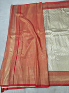 Cream and red Banarasi silk saree fabric with contrast border and textured weave