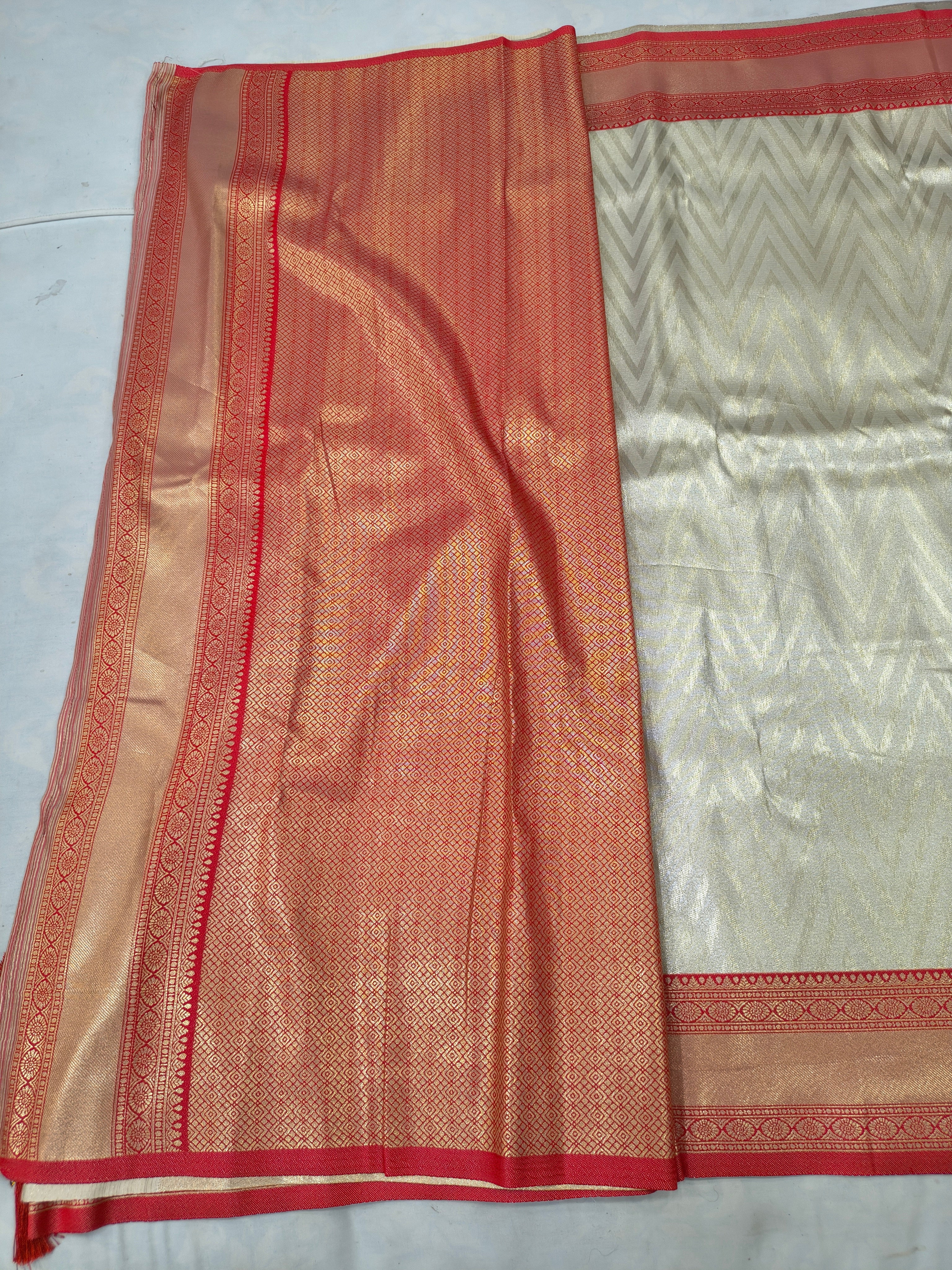 Cream and red Banarasi silk saree fabric with contrast border and textured weave