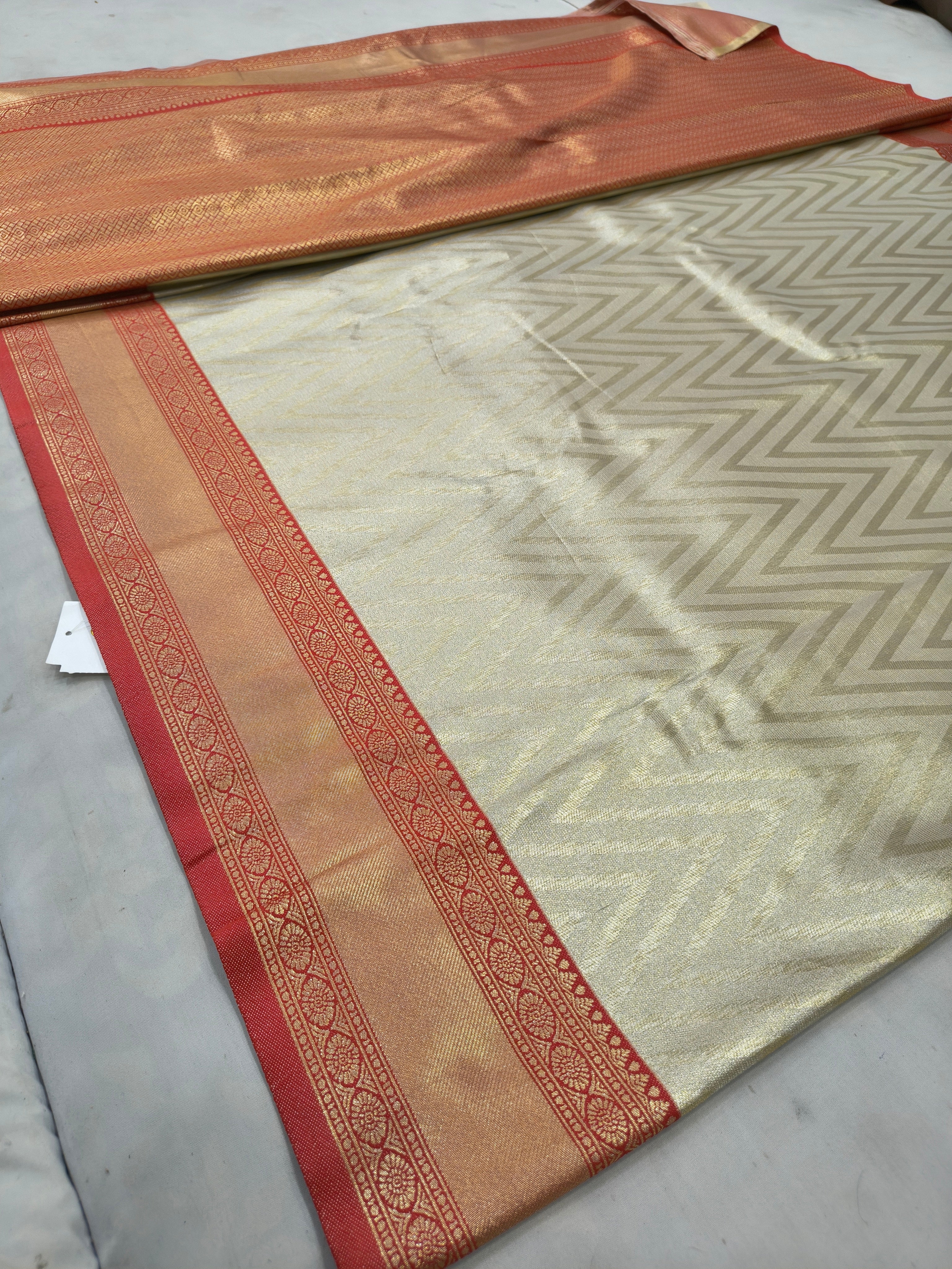 Cream Banarasi silk saree fabric with red woven stripes and gold-toned border