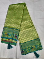 Folded green Banaras silk saree with blue border and tassels