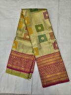 Silk saree with green-yellow geometric motifs and red border, unstitched blouse