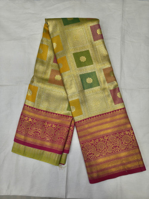 Silk saree with green-yellow geometric motifs and red border, unstitched blouse