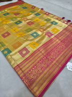 Banarasi silk saree with yellow square pattern, pink-red border, and tassel trim