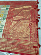 Gold and red Banarasi silk saree close-up with red ornate border and patterned body