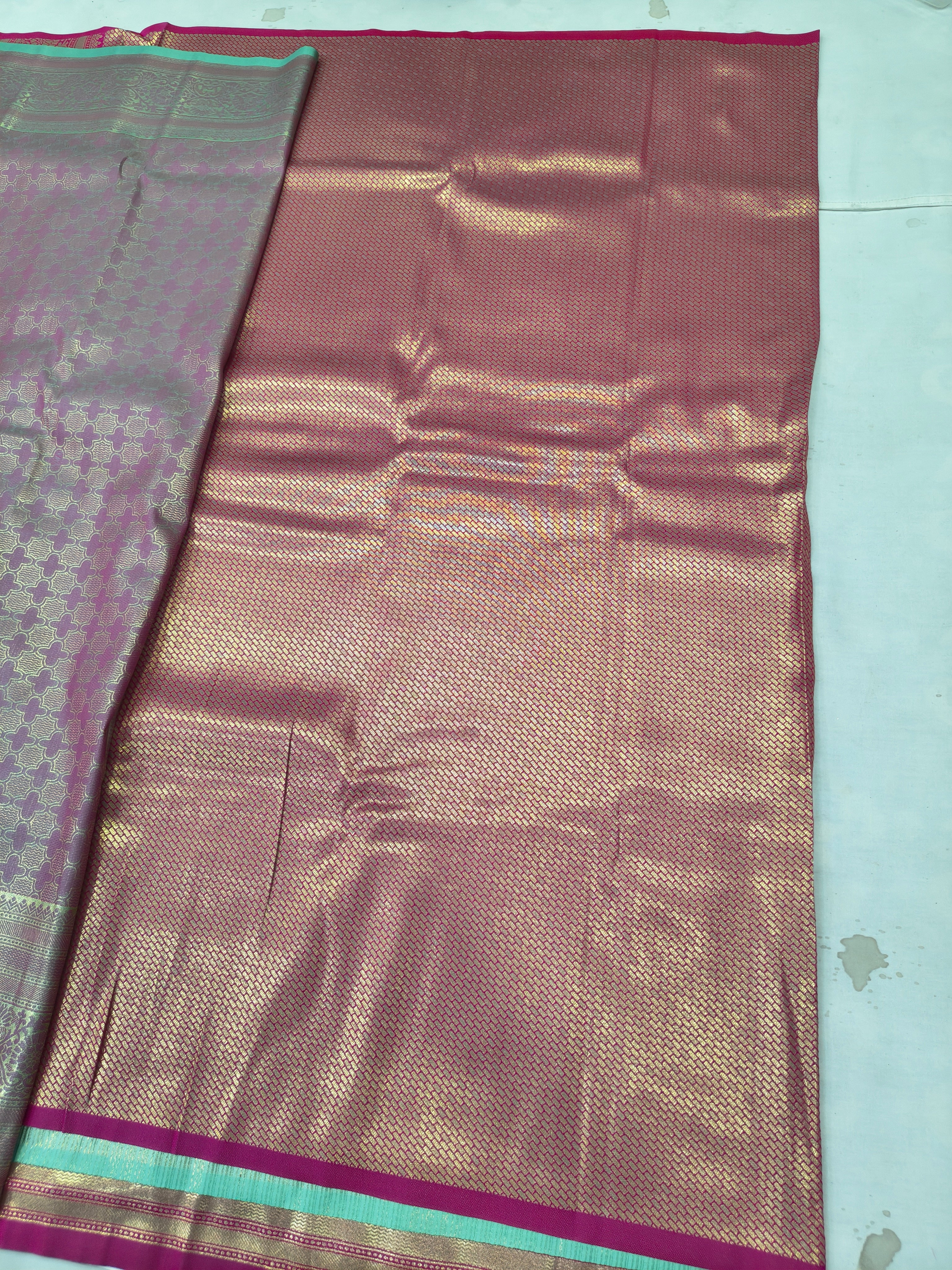Pastel silk saree with multicolor woven motifs and pink-gold border