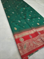 Teal green silk saree with scattered gold motifs and red border with paisley patterns