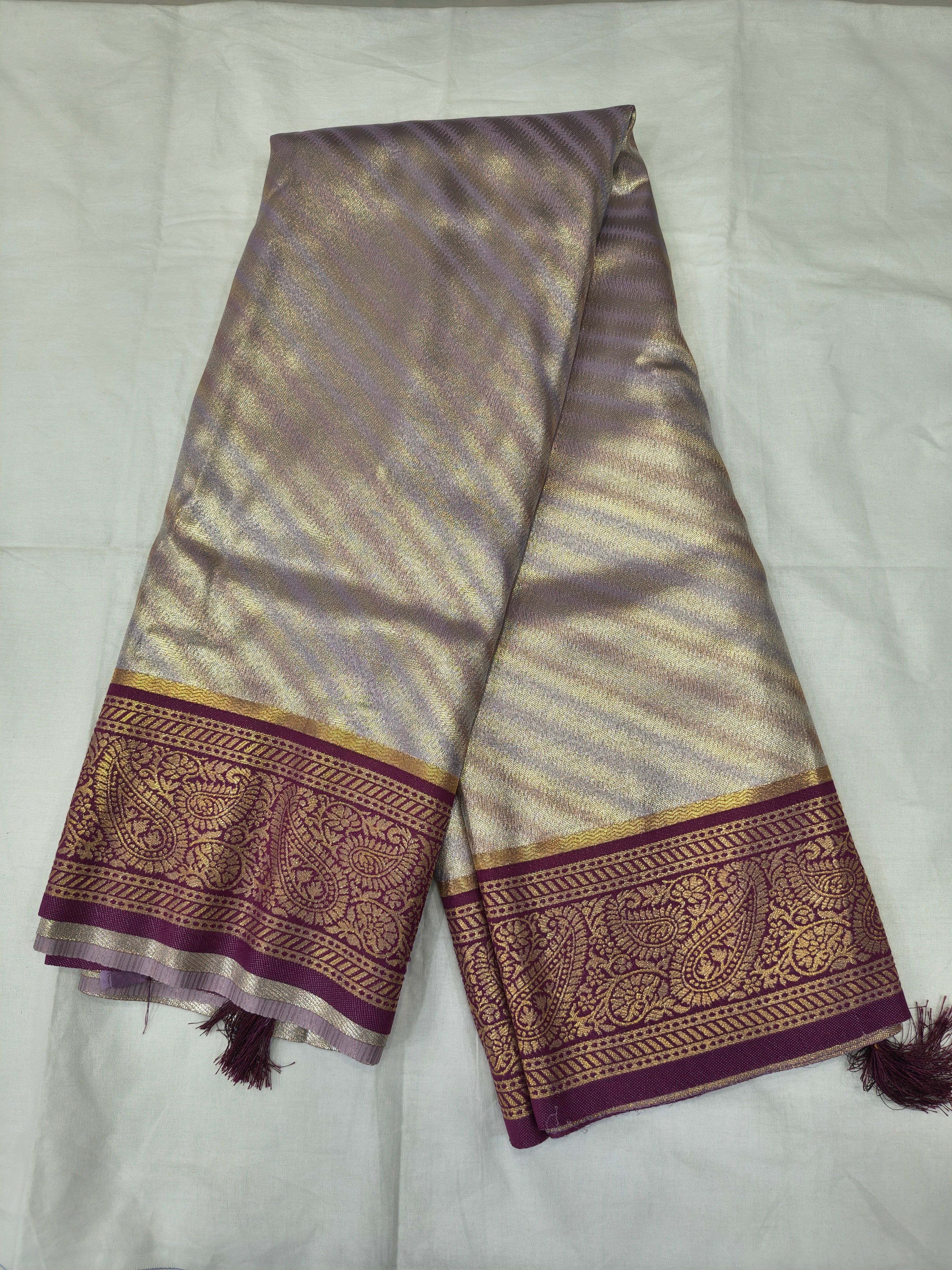 Silver and purple Banarasi silk saree with wide border and tassel fringe ends