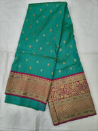 Turquoise saree with tiny gold motifs and maroon-gold border, unstitched blouse