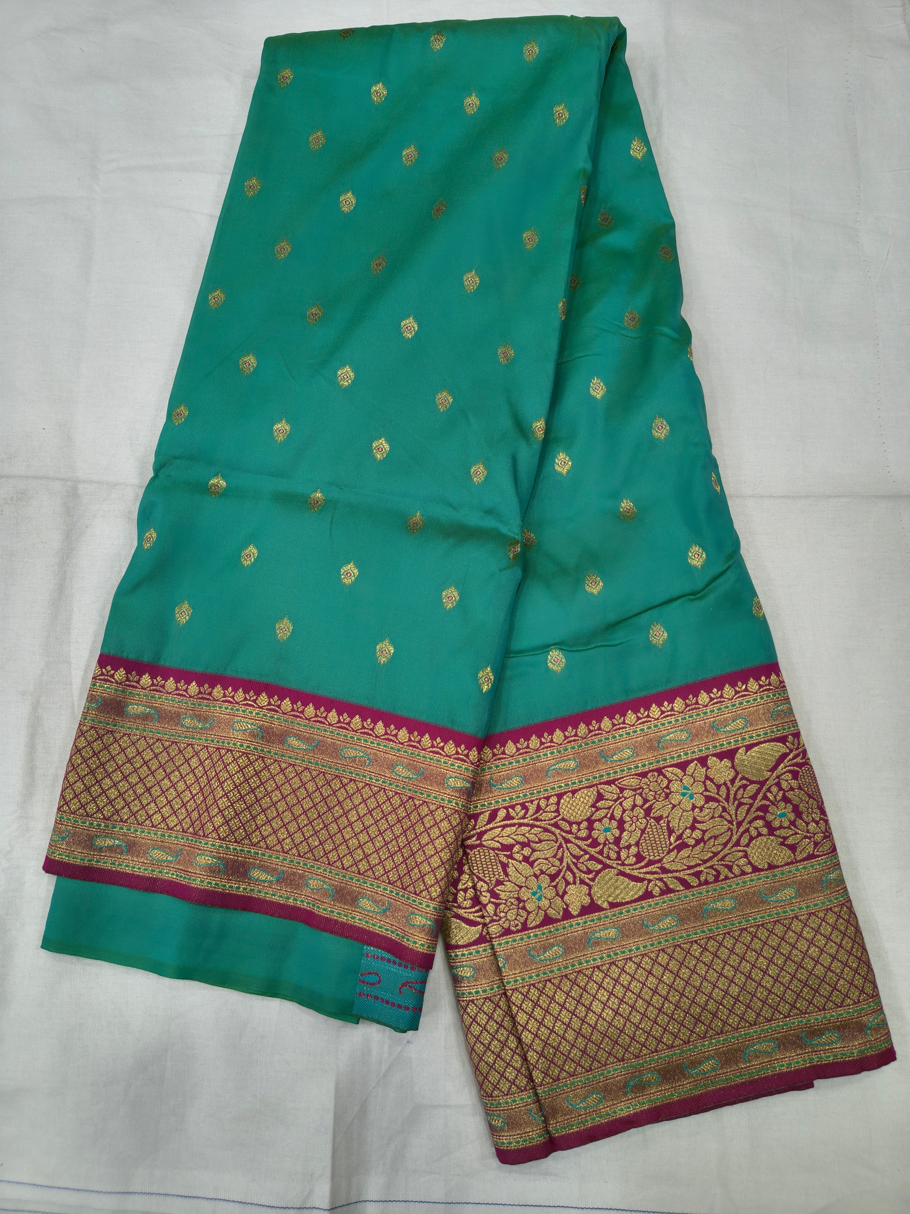 Turquoise saree with tiny gold motifs and maroon-gold border, unstitched blouse
