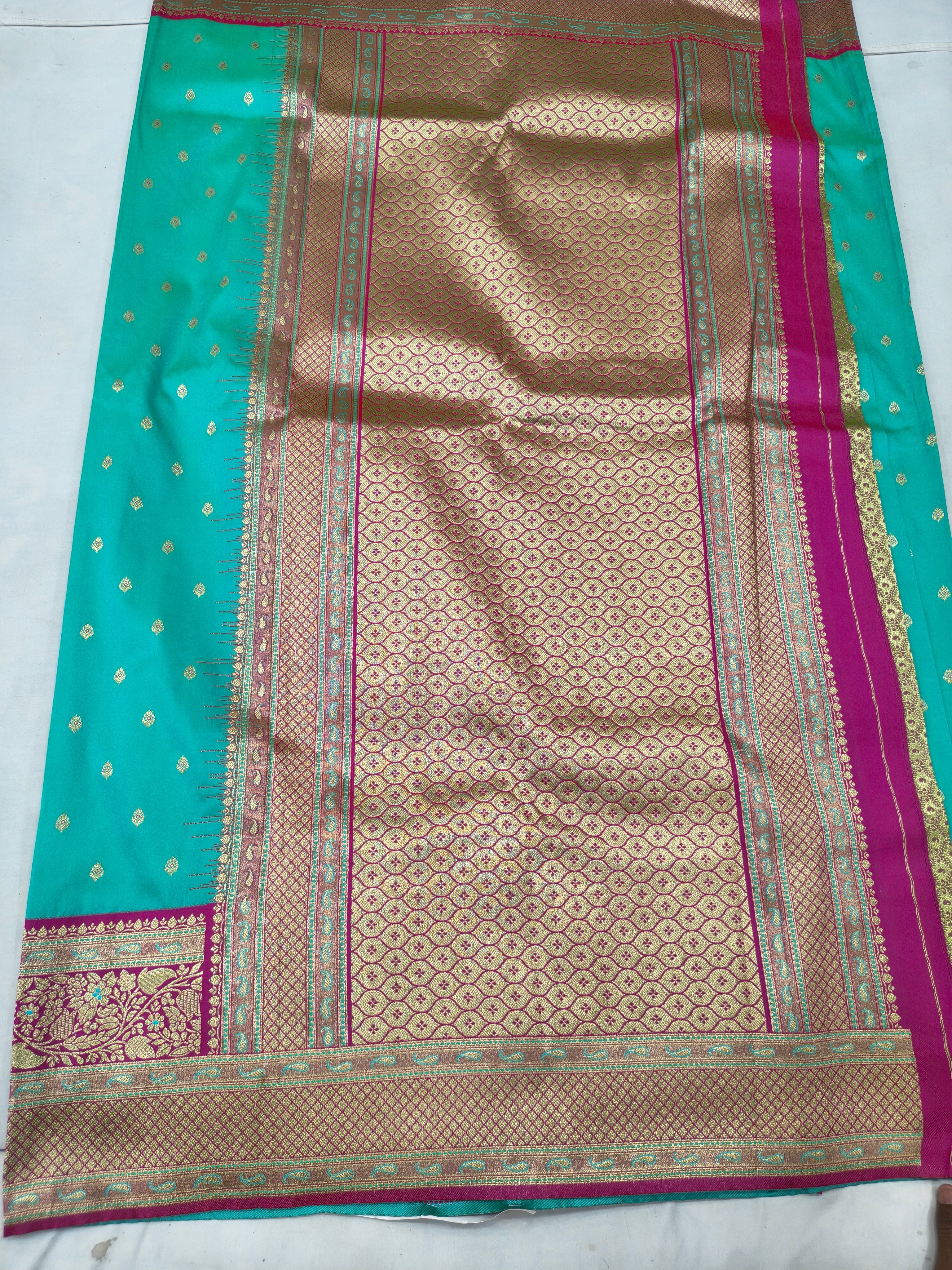 Banarasi pallu panel with maroon and gold motifs on turquoise saree