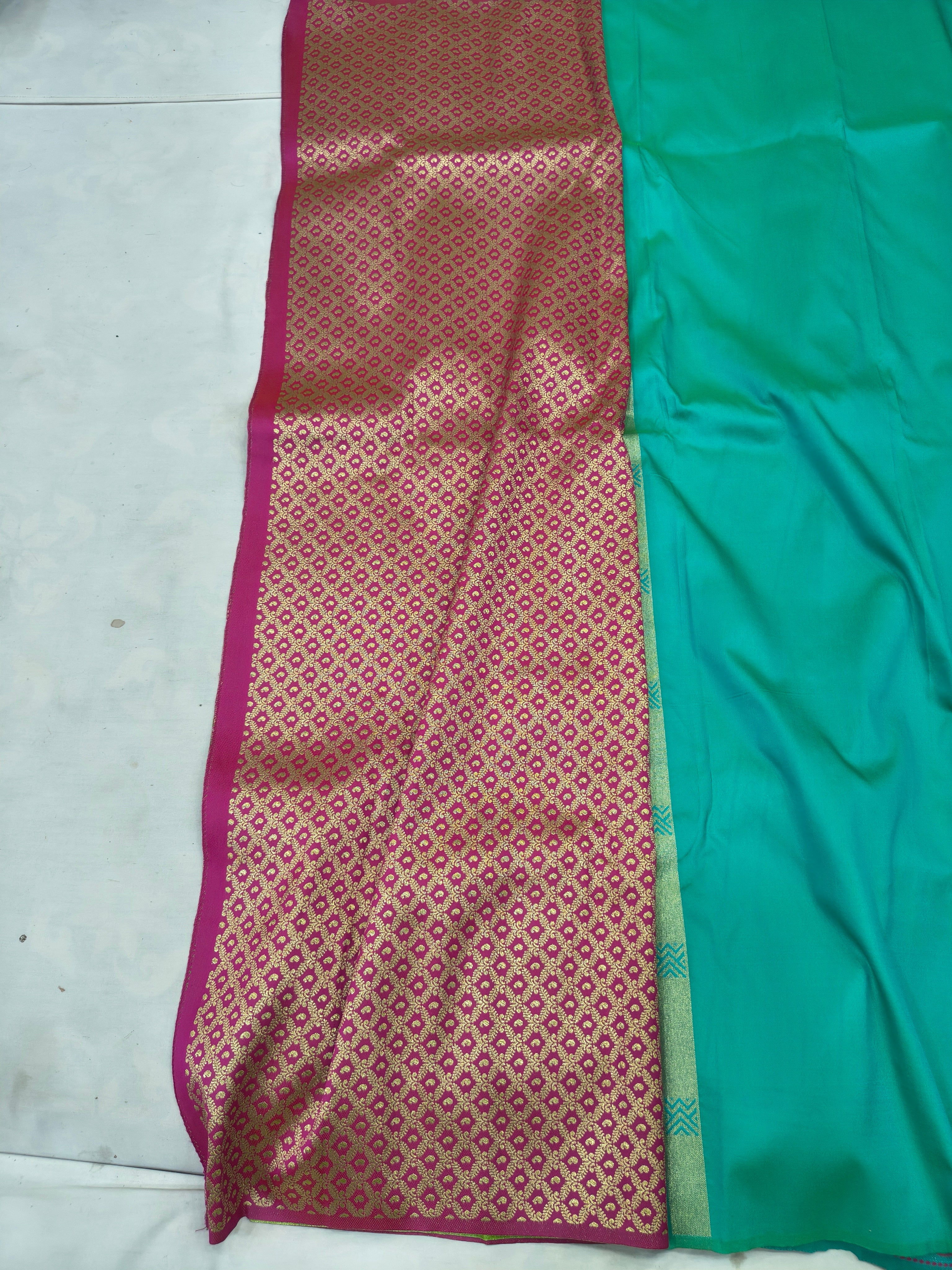 Turquoise and maroon saree fabric with patterned panel and decorative border