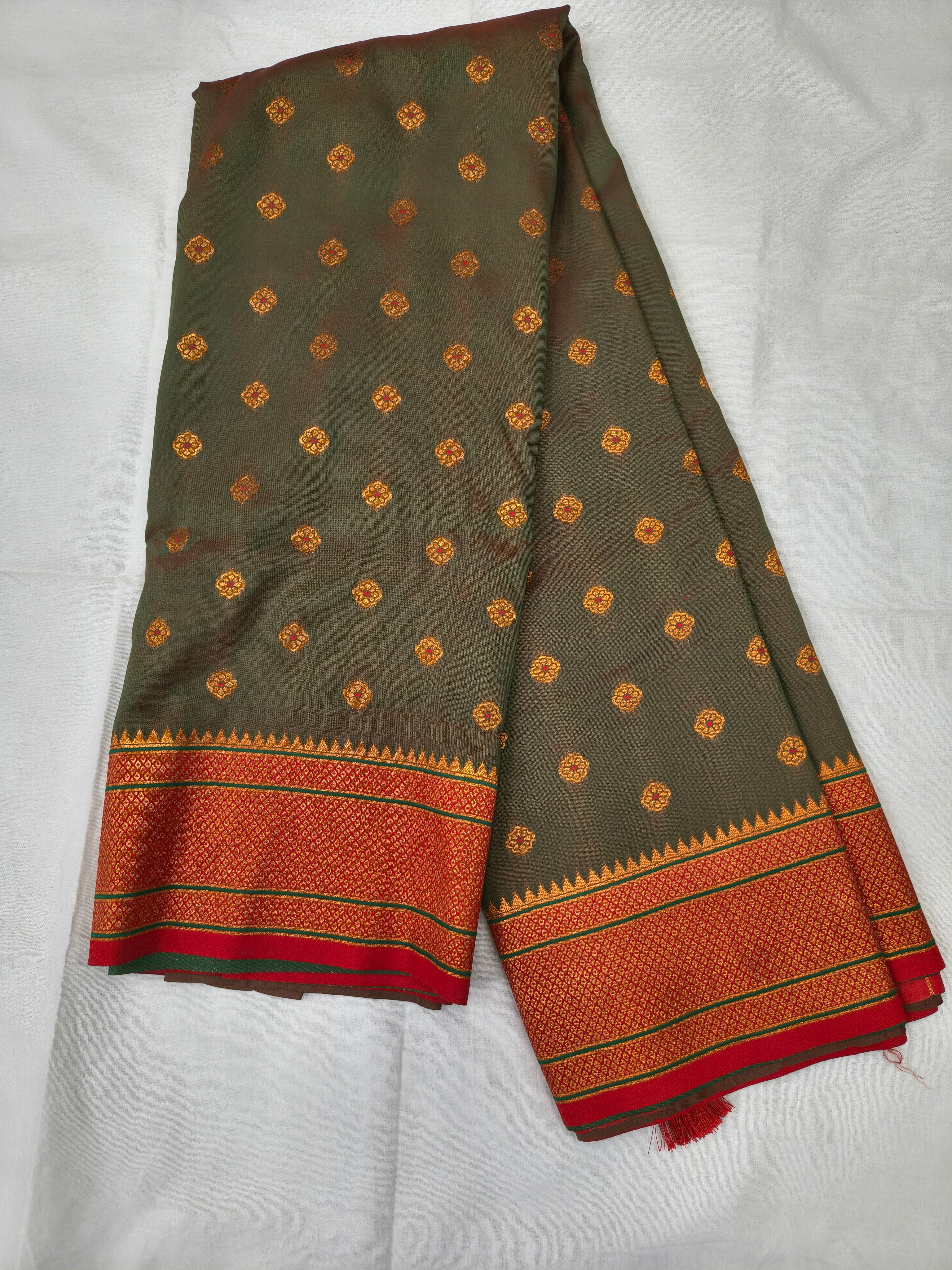 Grey-green Banarasi-style silk saree with orange border and small golden motifs