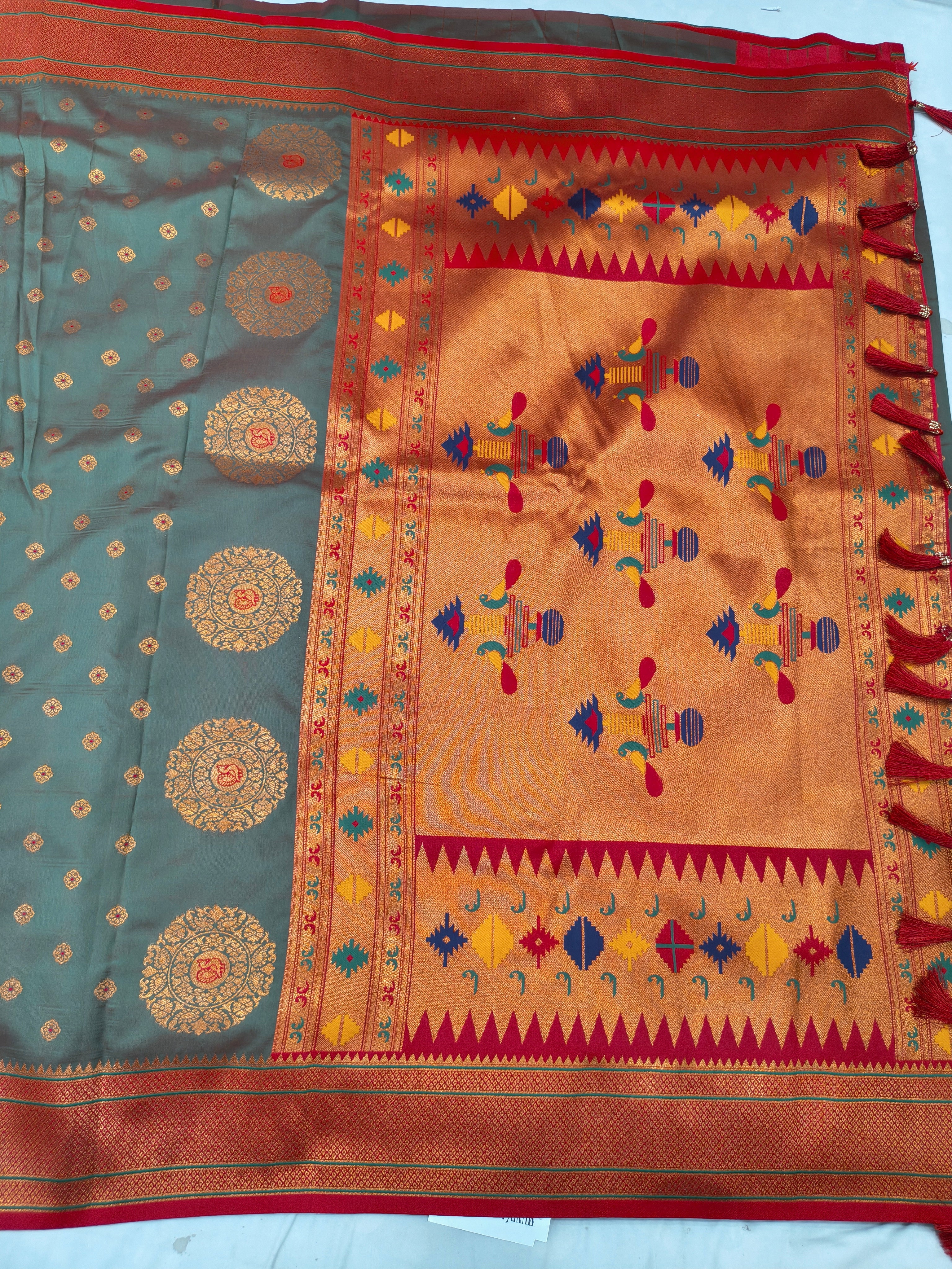 Banarasi-style saree pallu with orange center panel, multicolor embroidery and patterned border